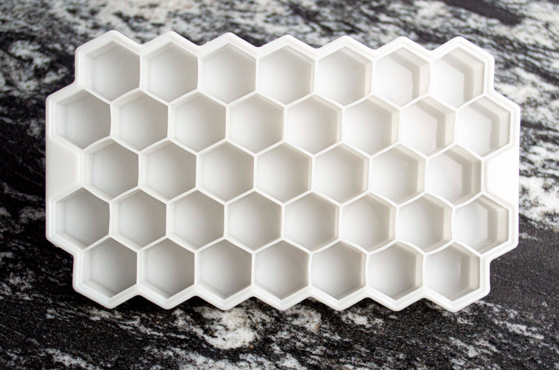White Silicon ice tray. Ice cubes are roughly 1/2" hexagons arranged in a 7 x 5 pattern.