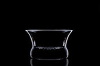 Glass Oaxaca with black background, lit in a way to show the outline of the glass with light.