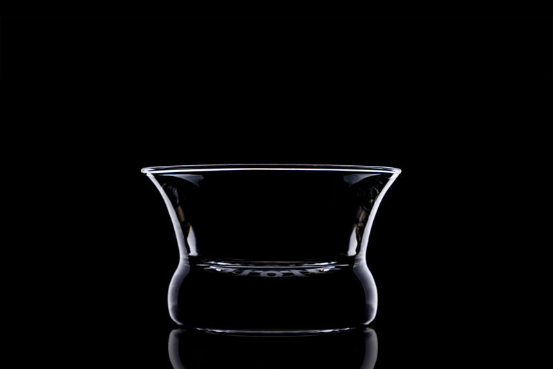 Glass Oaxaca with black background, lit in a way to show the outline of the glass with light.